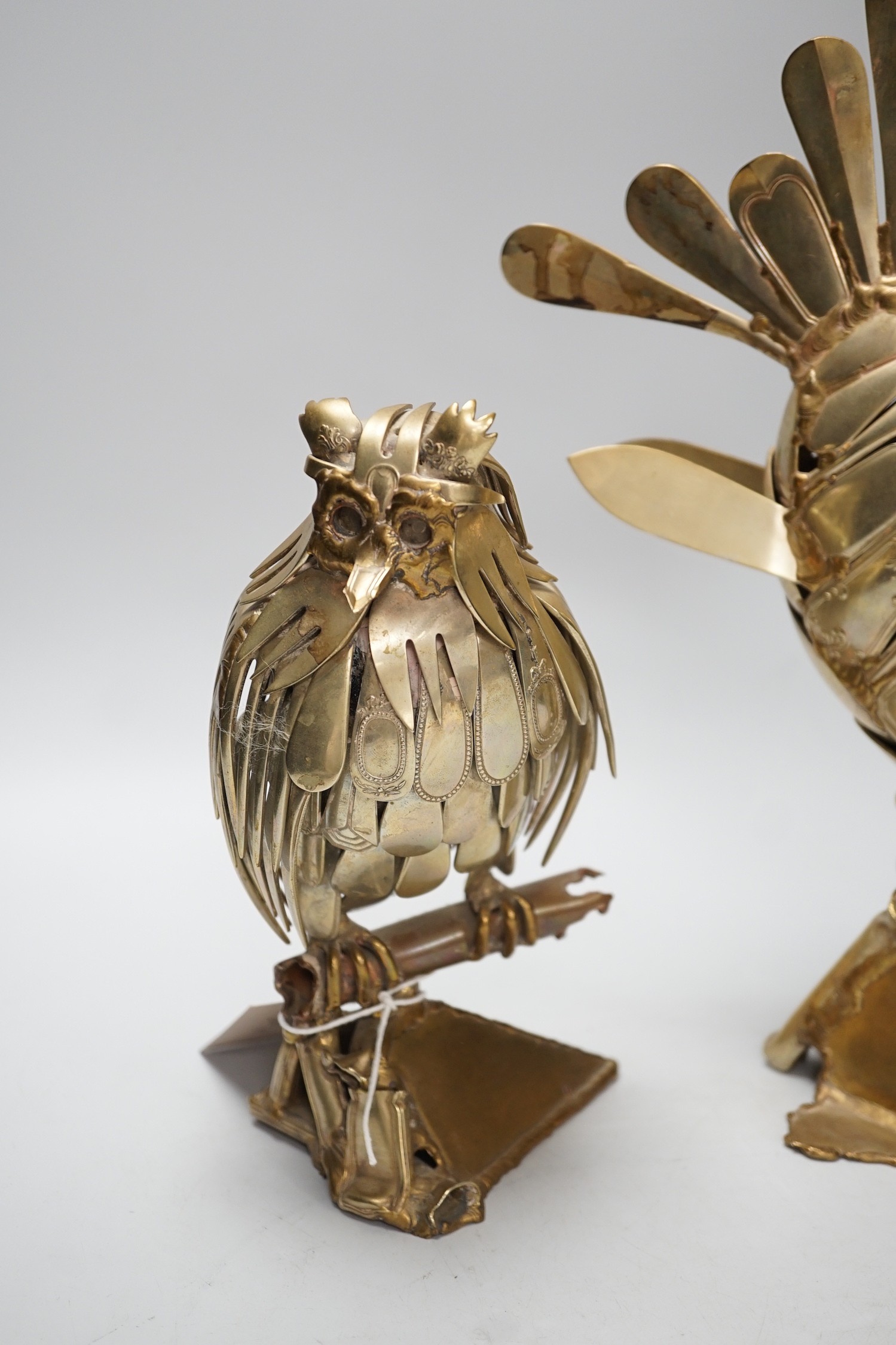 Two stylish nickel ornaments; an owl perching and an exotic fish, constructed from old knives and forks, one indistinctly signed and dated 1990, Tallest 35cm